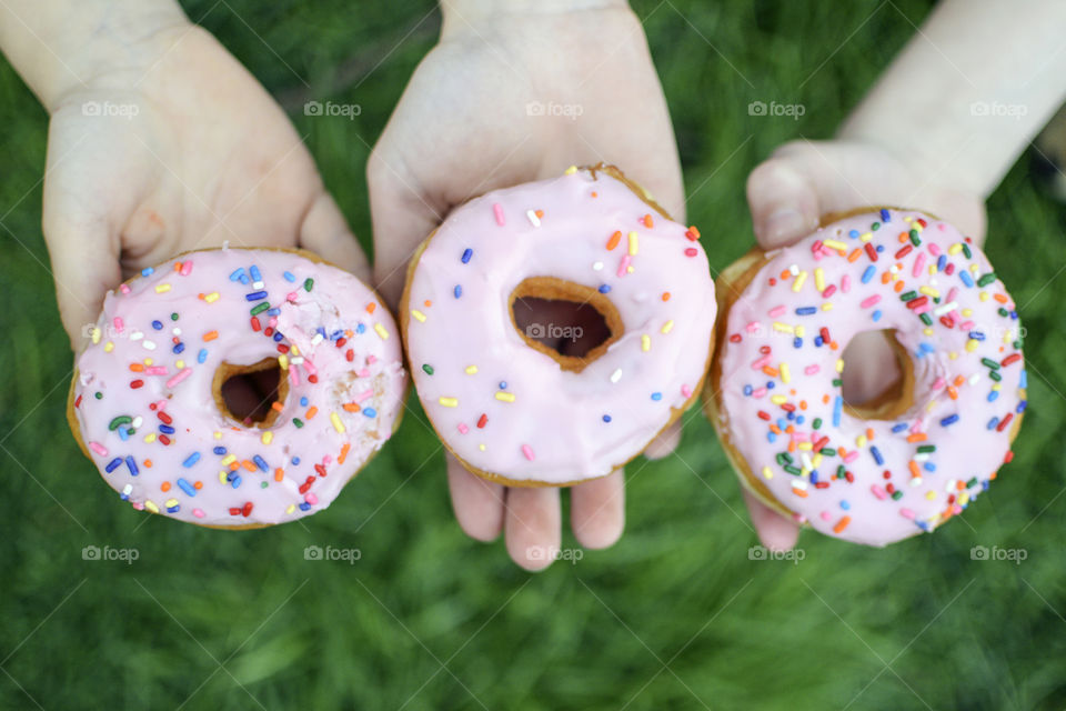 Hands showing donuts