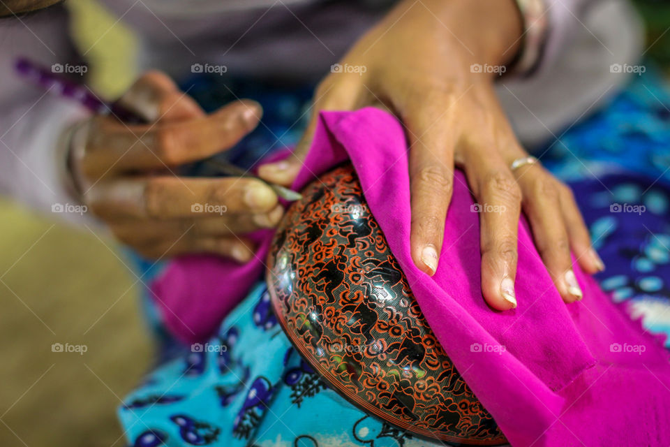 Skilled hands of a women lacquer crafts person