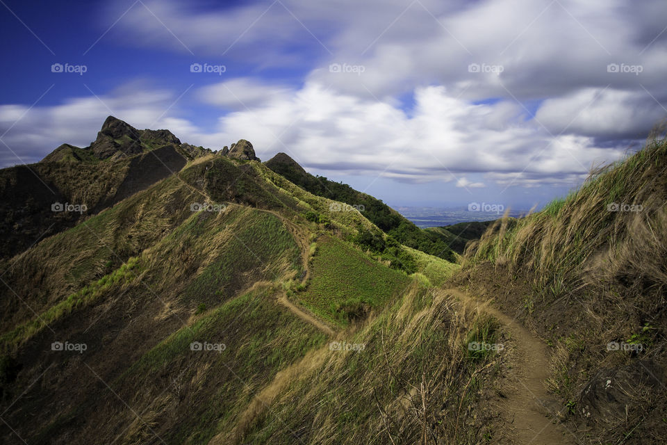 Scenic view of mountains against cloudy sky