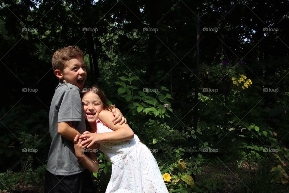 Siblings from the United States of America sharing a laugh together 