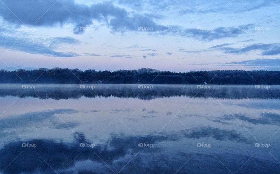 foggy morning at the lake in polish countryside