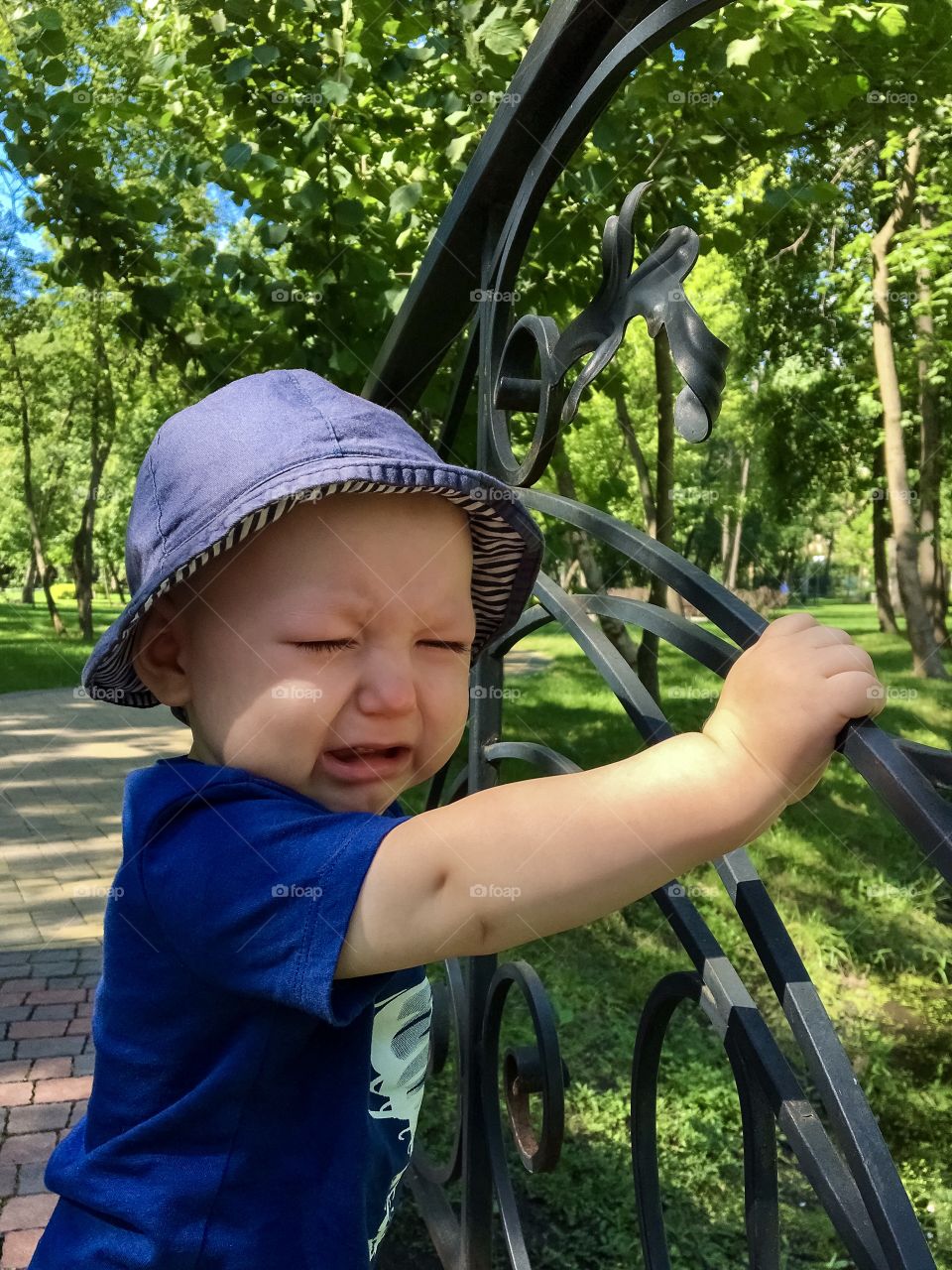 Little boy crying in the park 