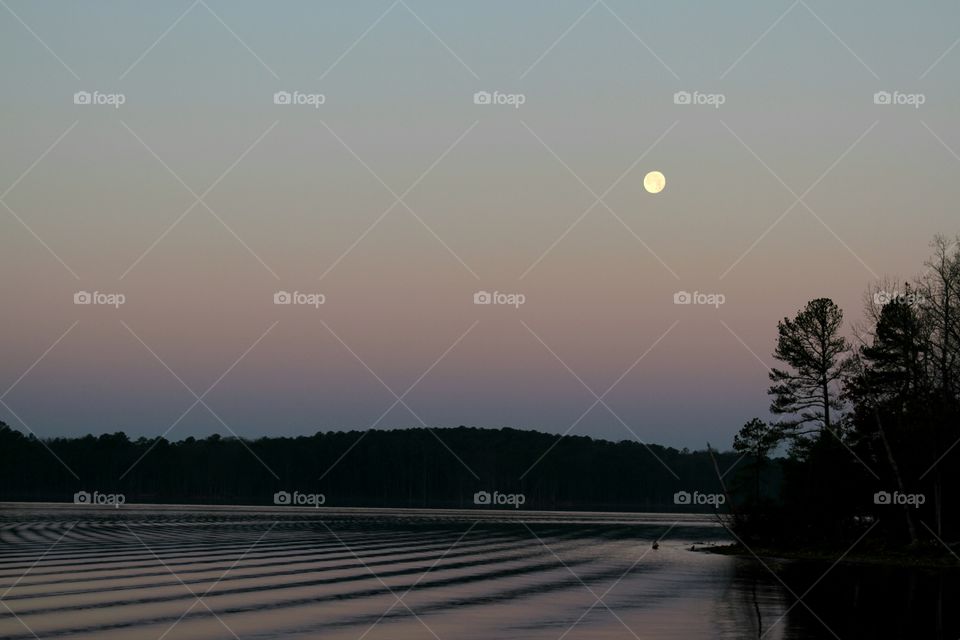 moon over lake at dawn