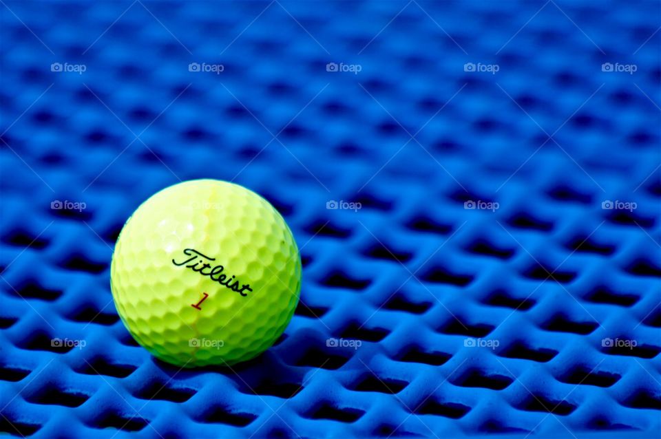 Golf ball on blue picnic table