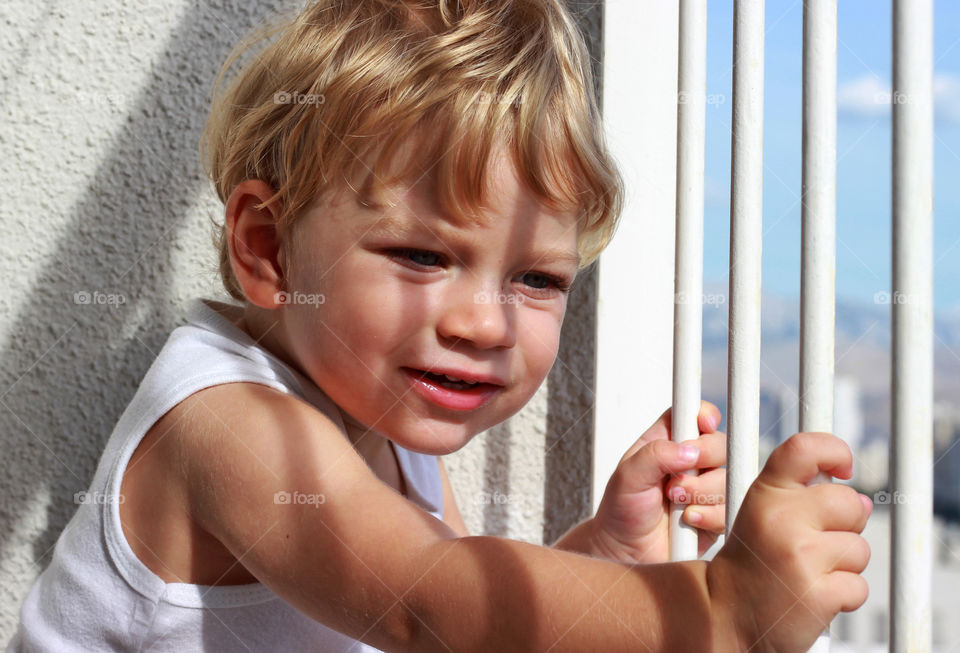 Fence shadow on the face of baby