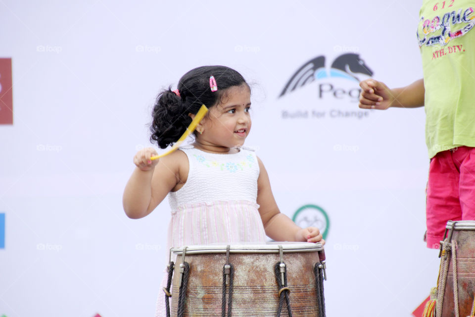 Girl child playing musical instrument