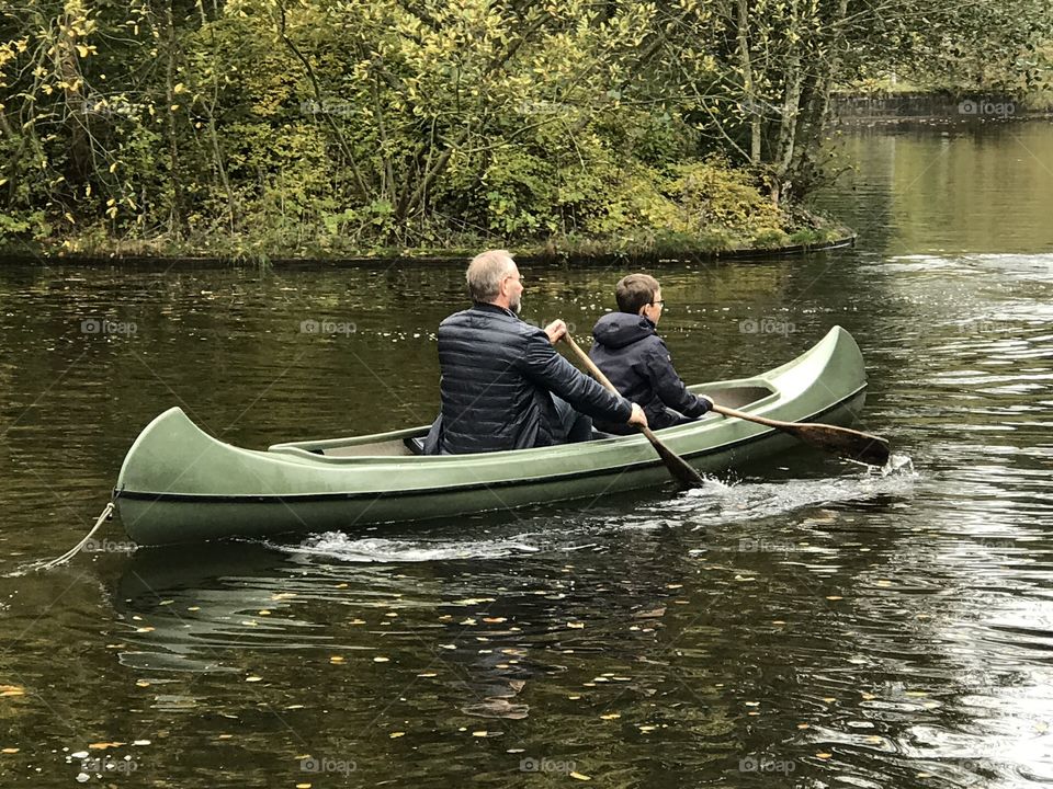 Family enjoying fun at water in a canoe