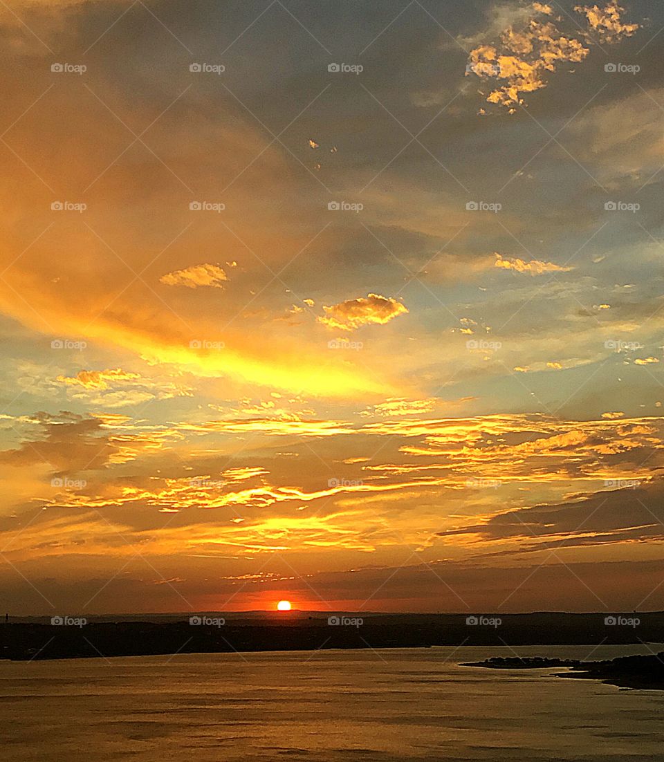 Sunrise, sunset and the moon - Glorious sunset descending in the valley with a miraculous colorful cloud laden sky