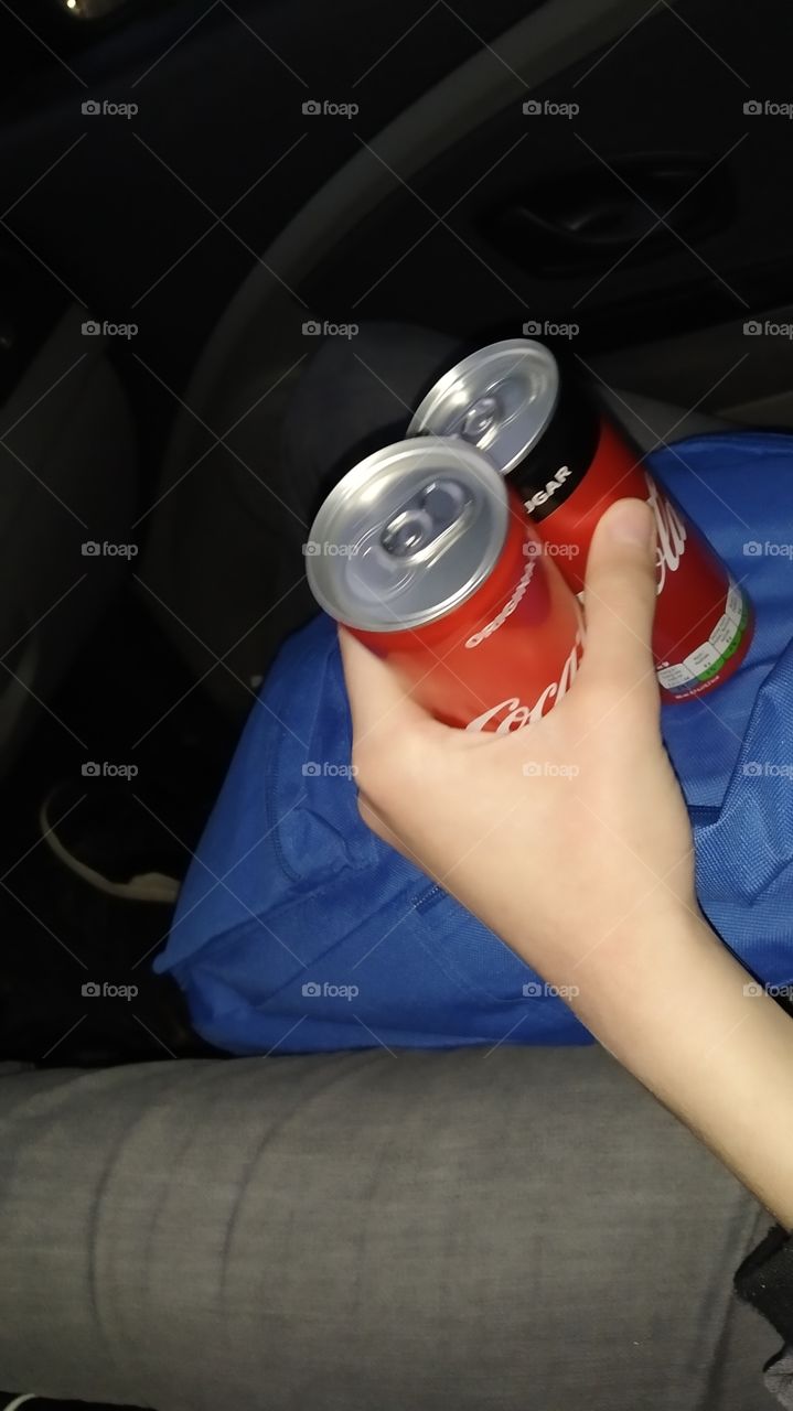 Teo Coca Cola cans in hand