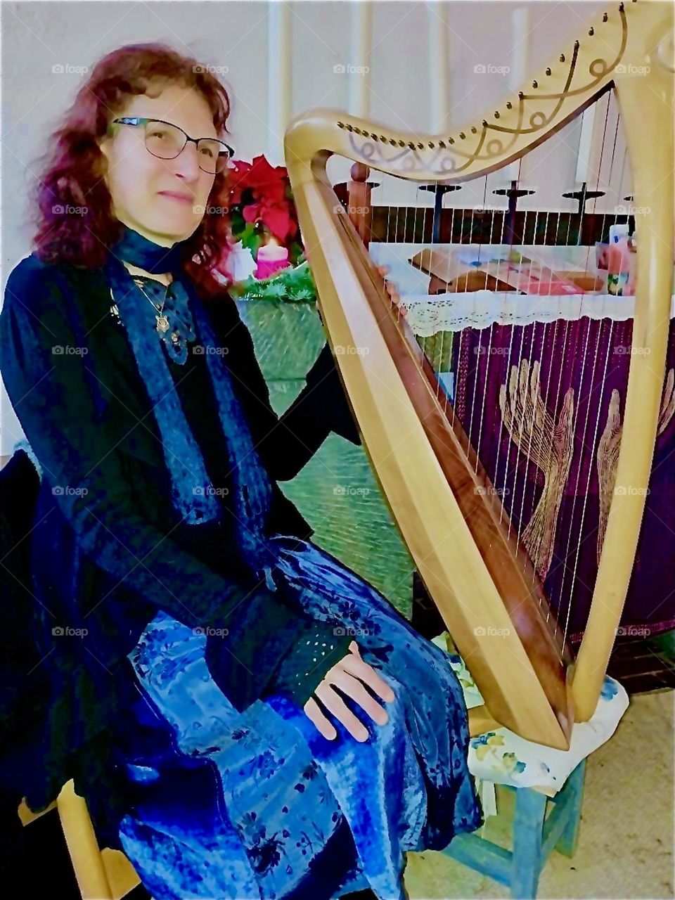 The lady plays the harp and she sings and writes songs, too. She lives in “Bavaria”, Germany where she appears regularly in local churches displaying her craft. And a harp relates to the heavenly realms also. 2023. Hypnotic Productions