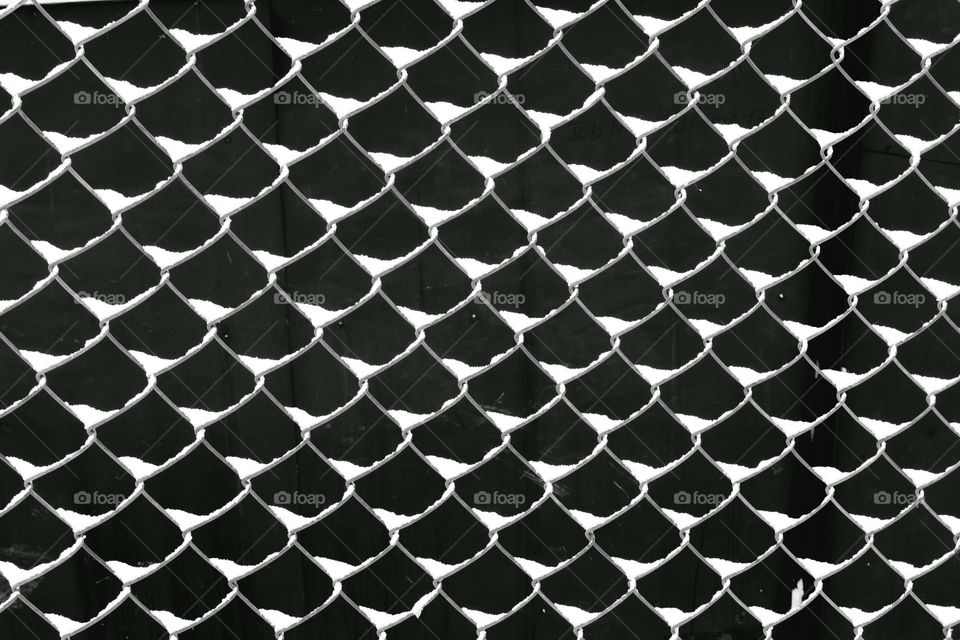 snow on mesh fence