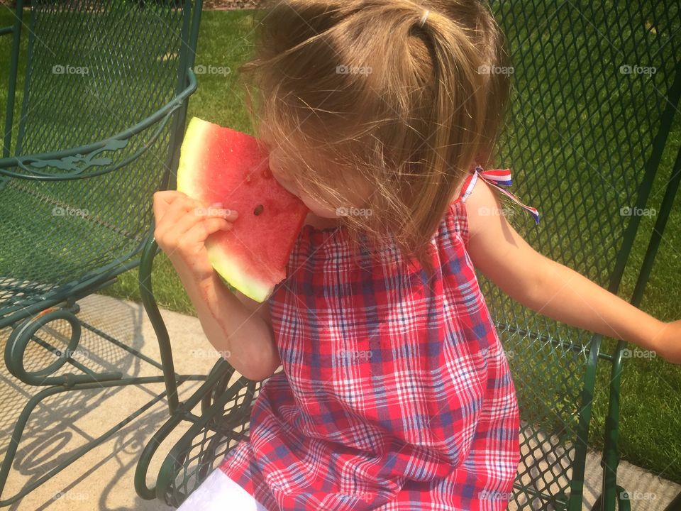 Elevated view of a girl eating watermelon
