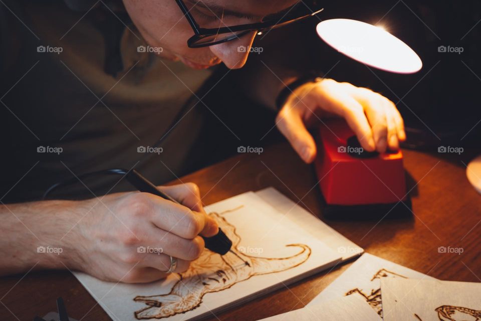 Man working with wooden picture. Craftsman, artisan 