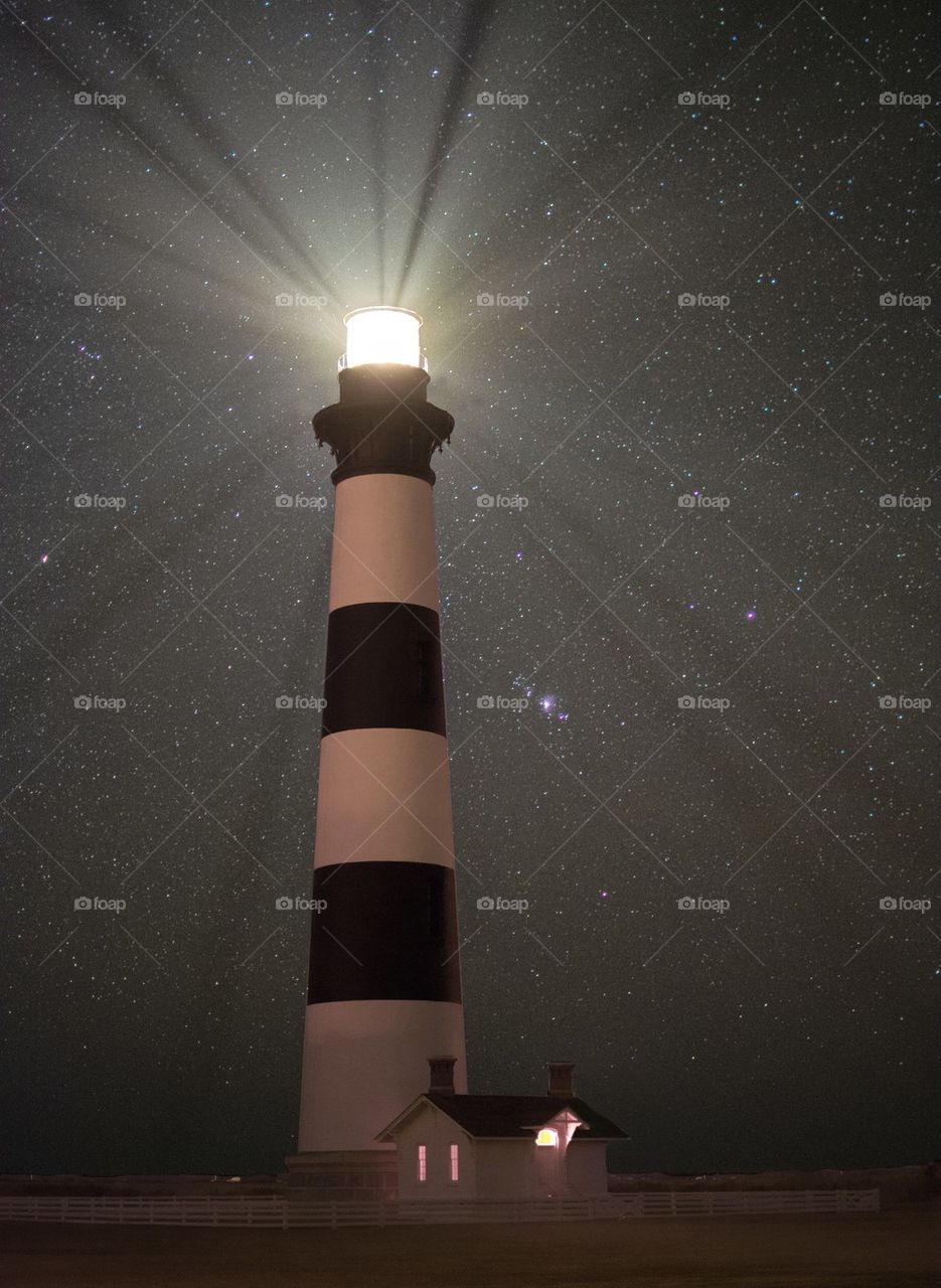Stars behind a lighthouse