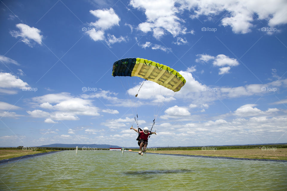 parachute flying over the water