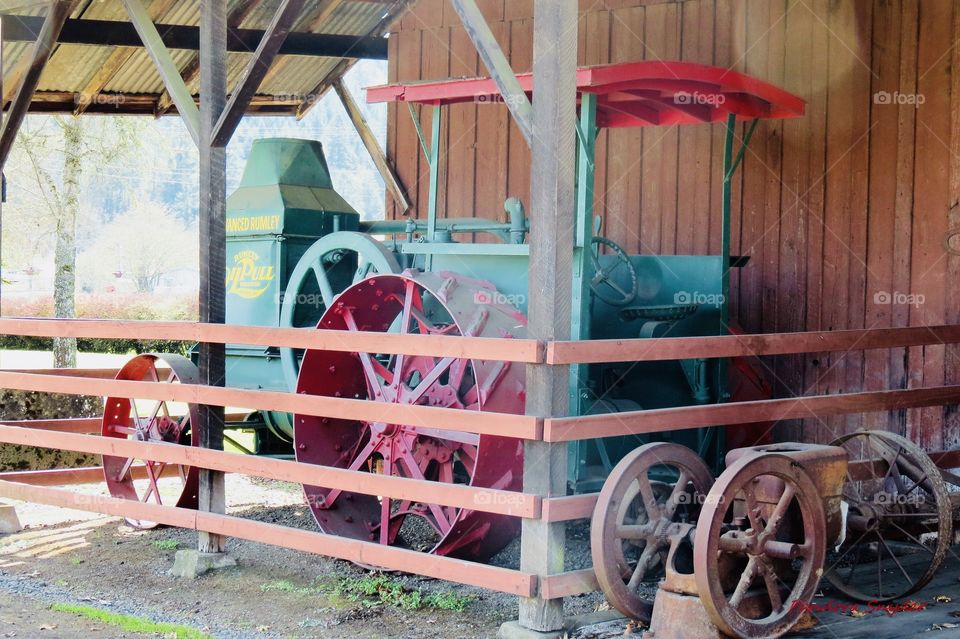 Early 1900’s Rumely Oil Pull Tractor Displayed In Front Of An Old Historic Barn. 