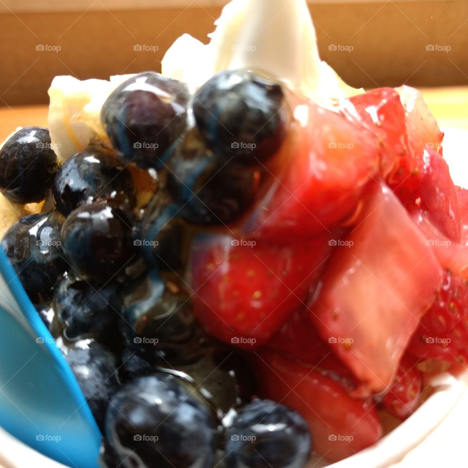 blueberries and strawberries on yogurt