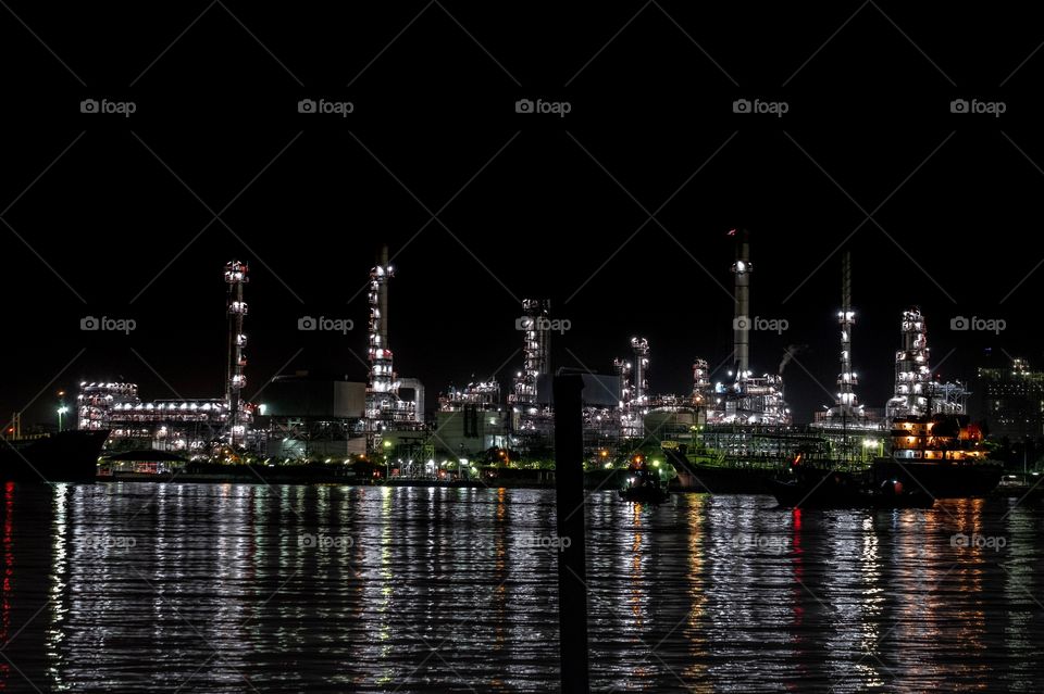 Beautiful light of oil Refinery plant beside the river