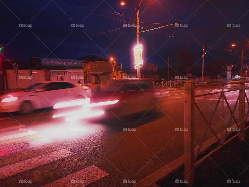 passing cars on the highway at night.