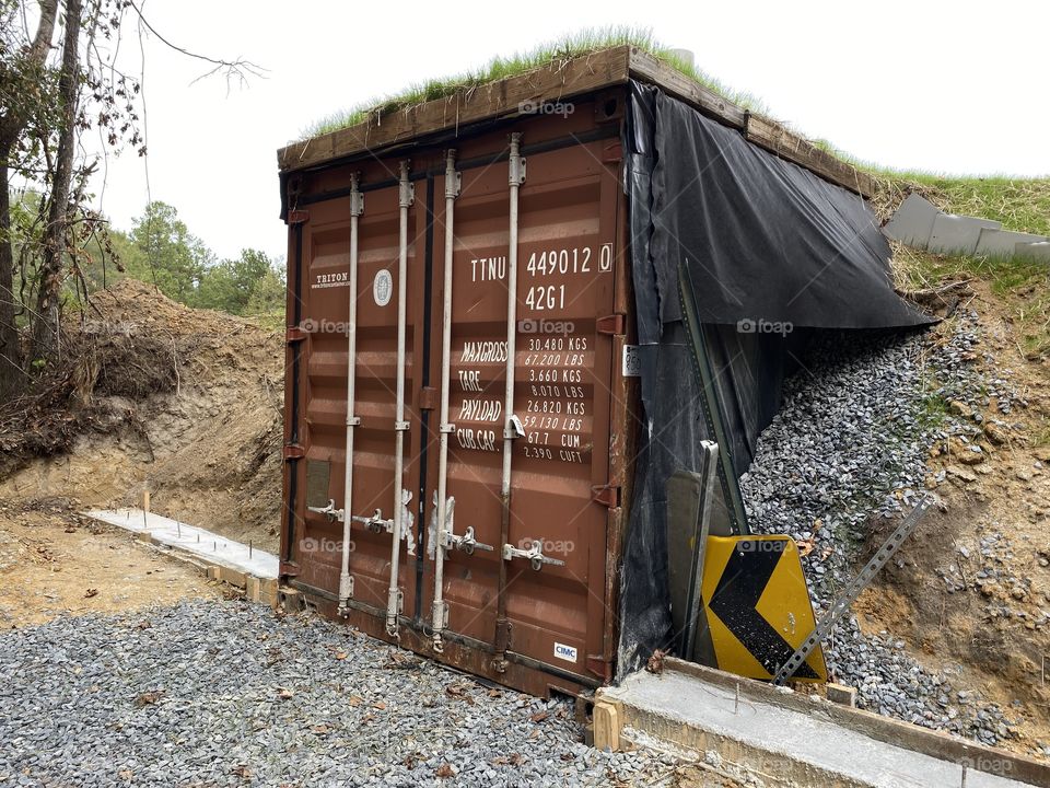 Storm shelter- two wall supports on either side of the entrance. The walls will protrude out in front of the door and at an angle to prevent trees from falling and blocking the door.