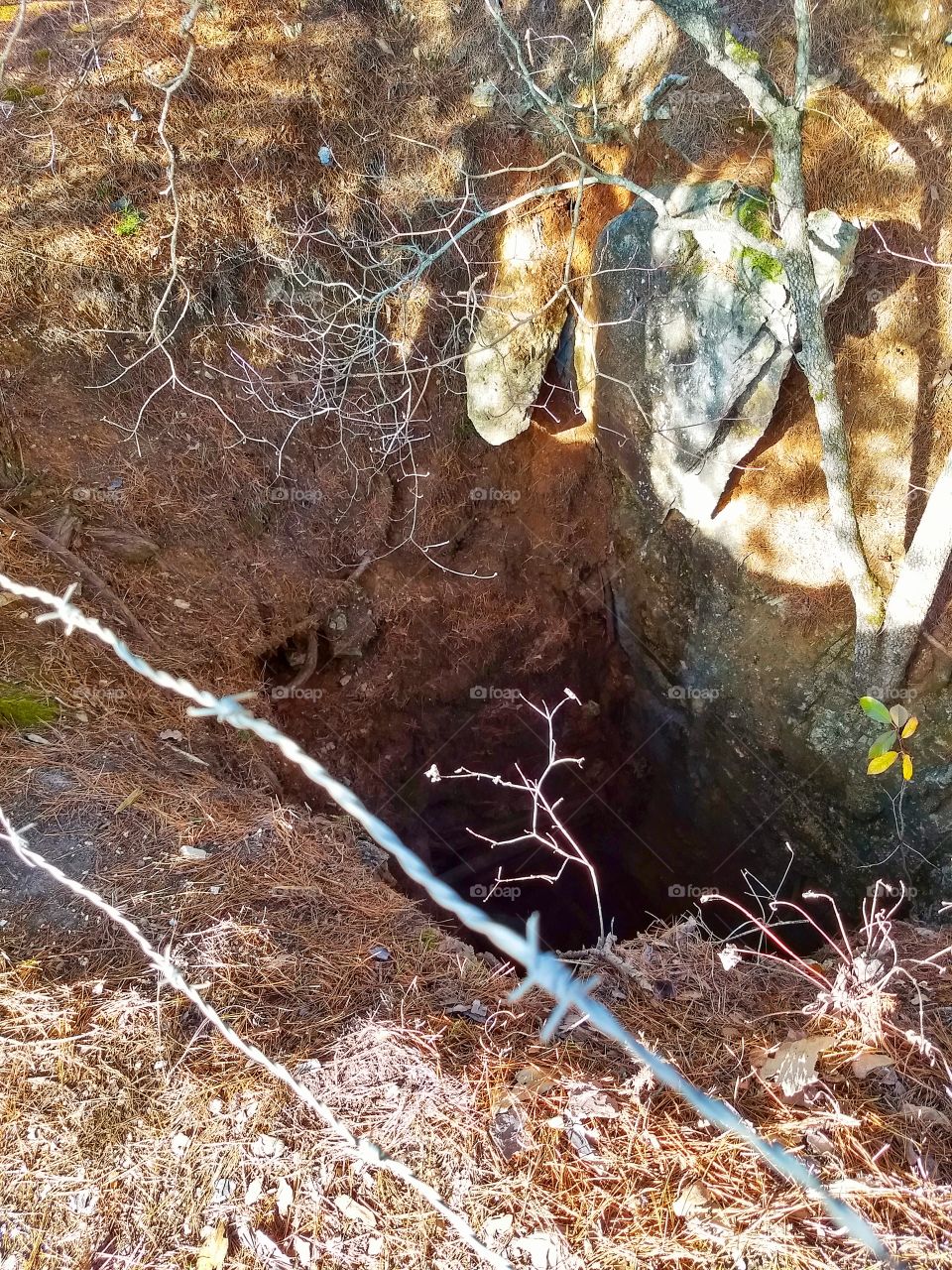 Mine shaft, open pit, along a hiking trail at Murder Rock, Branson Missouri.