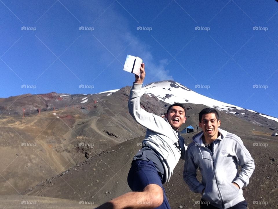 The volcano and us . Pic taken while I was on vacation with my cousin in the south of Chile, Villarrica. That's the name of the volcano too. 