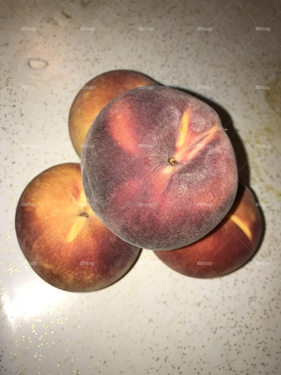 Four peaches forming a hilltop.