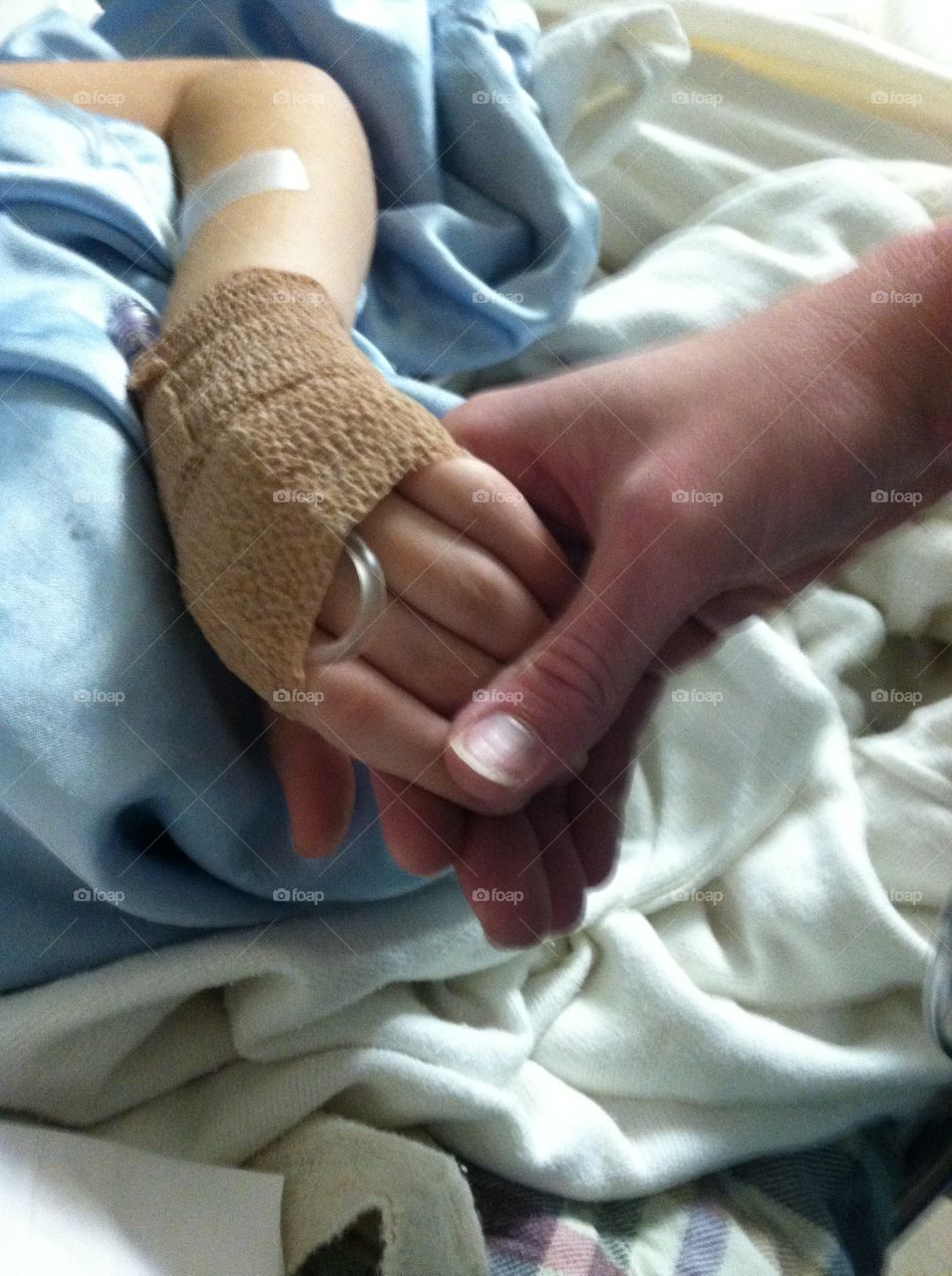 Holding my childs hand after surgery