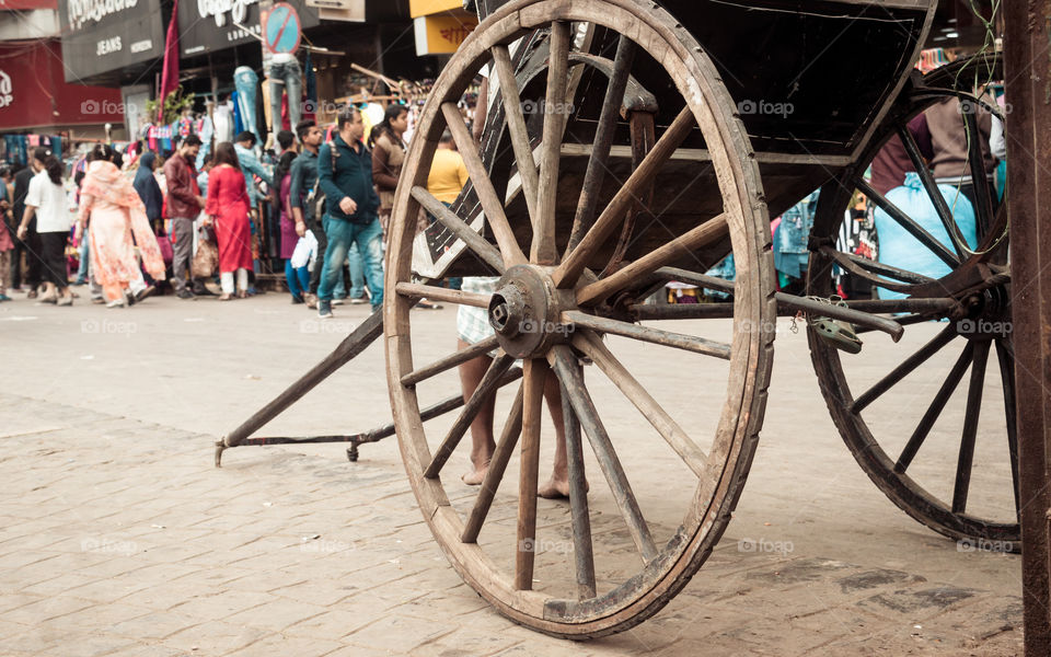 KOLKATA, WEST BENGAL, INDIA - JANUARY 5 2019: Traditional hand pulled rickshaws, also called " tana rickshaw", parked on the streets. Mode of human powered transport a runner draws a two-wheeled cart