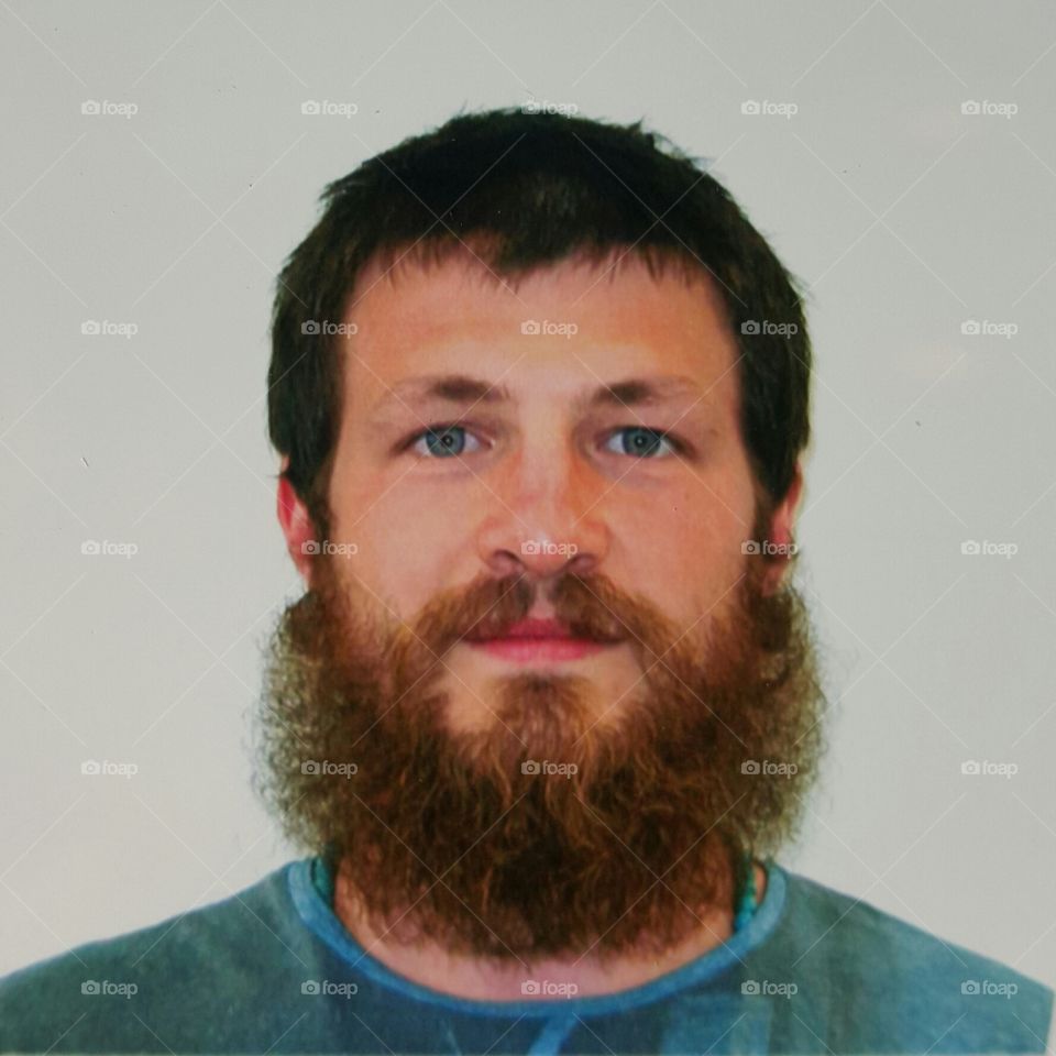 Passporting. A photograph of a passport-style photograph I took of myself for a visa-filing process.