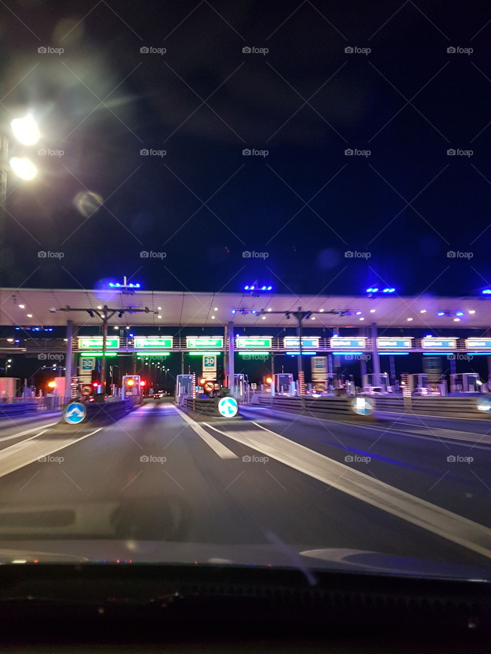 toll booths at bridge with lots of lights