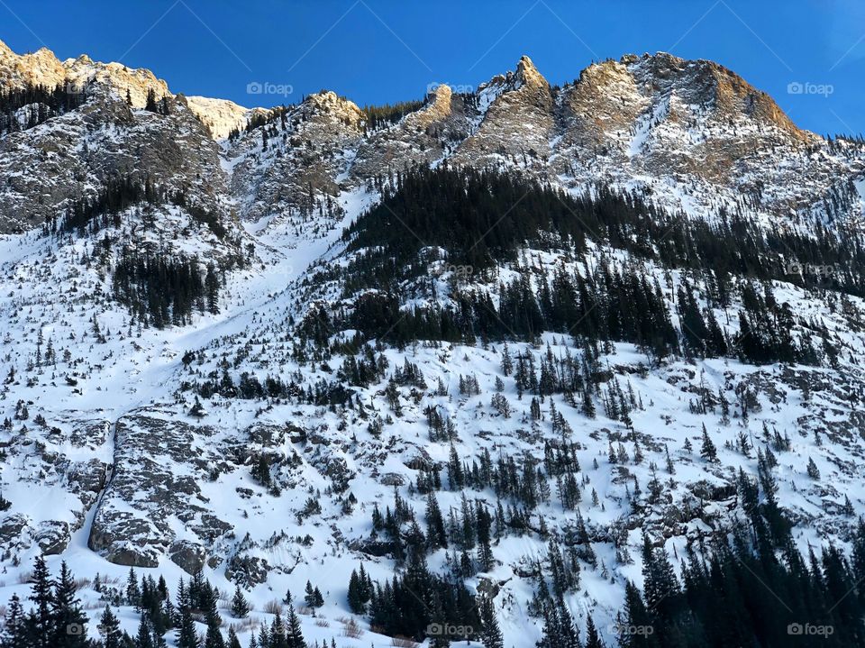 Sunset on the snow covered mountains. A few sunny peaks.