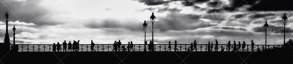 Silhouettes on a bridge