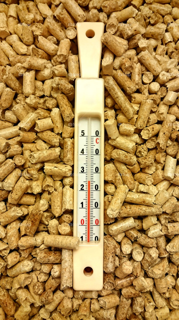 Thermometer on Wood Pellets. Heating Your Home With Wood Pellets