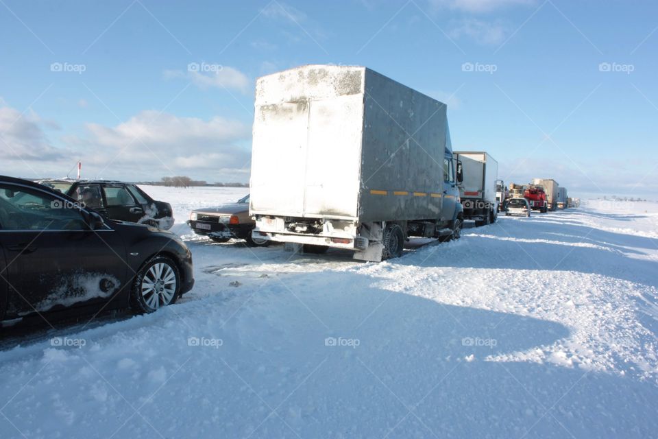 Car traffic in the highway full of snow 