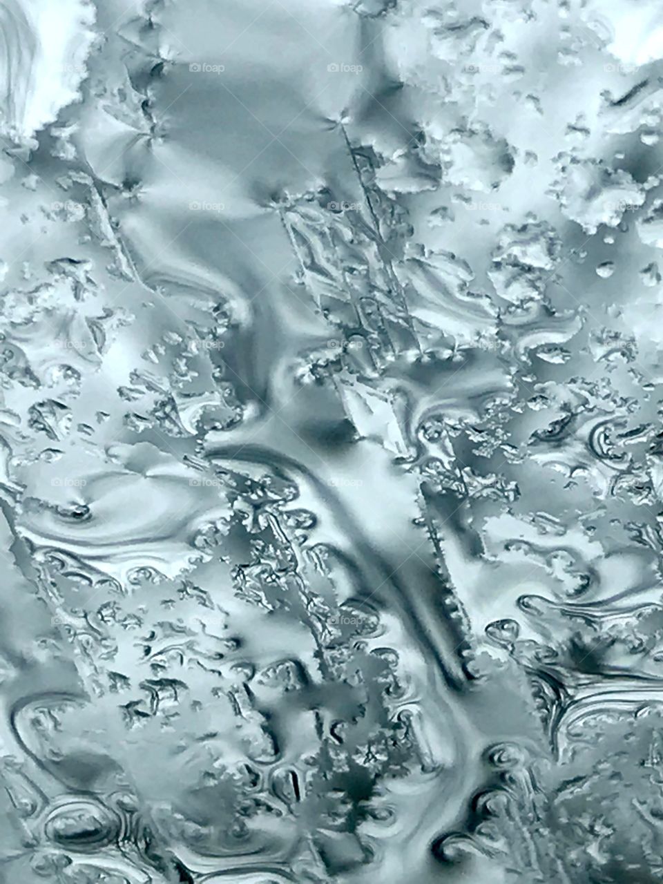 Shapes of raindrops on the glass