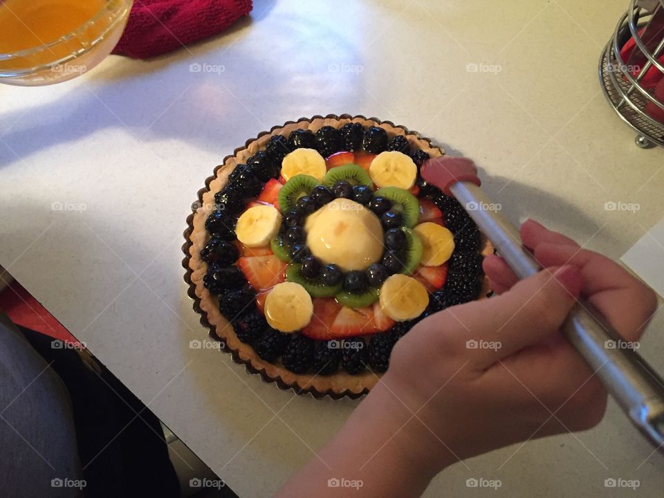 Dessert for Easter dinner.  A homemade fruit tart and now the finishing touch: apricot glaze 