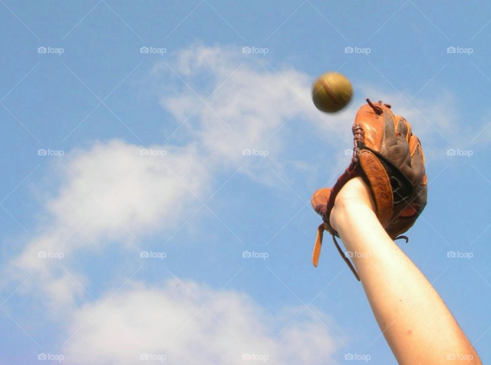 Person with baseball catching ball