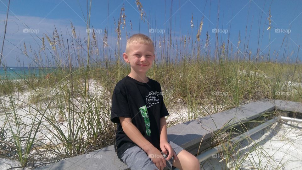 Cute little boy on beach. This is a photograph of a cute little boy on a white sand beach in Florida.