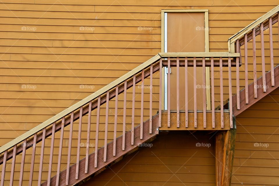 Yellow door and stairs, creating a beautiful and simple geometric pattern