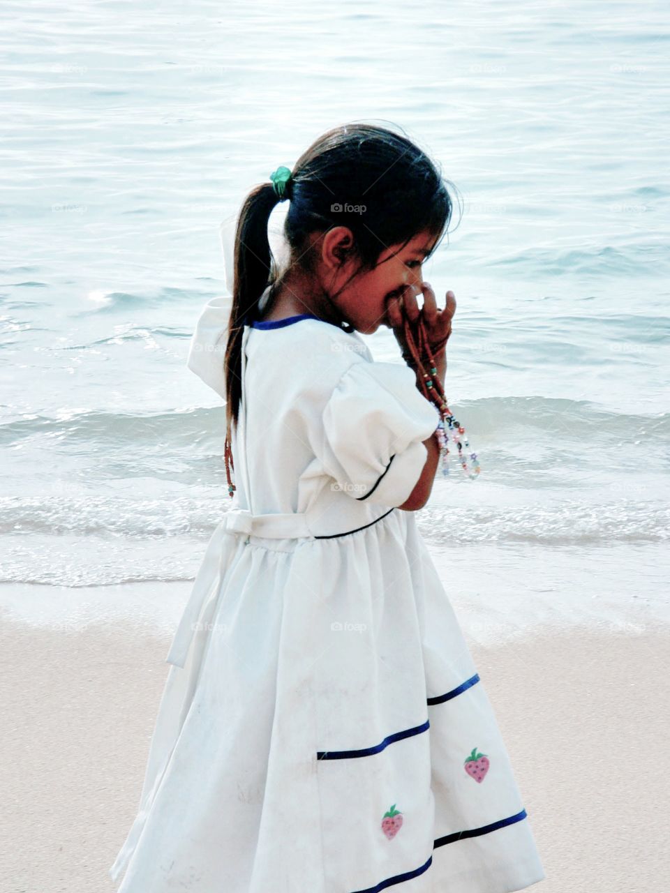 Child on beach from church