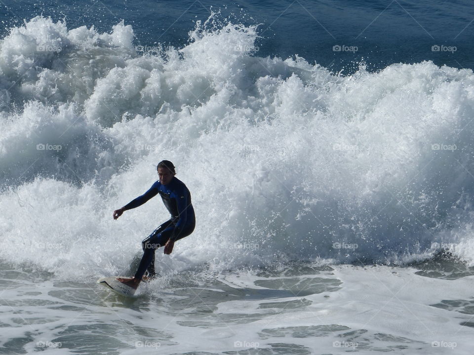 Full view surfer leading white water