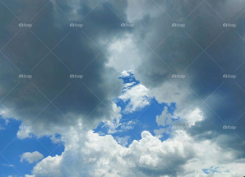 Bright clouds and dark clouds in the blue sky