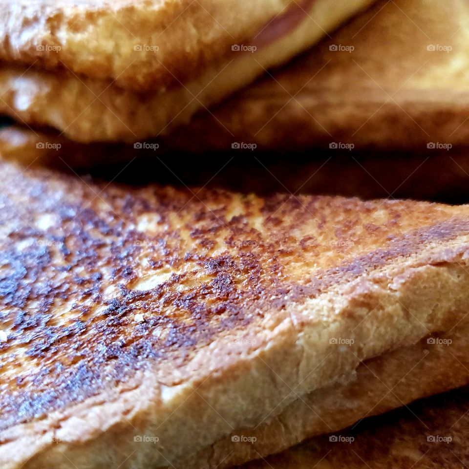 Closeup texture of a hot delicious toasted ham and cheese sandwich