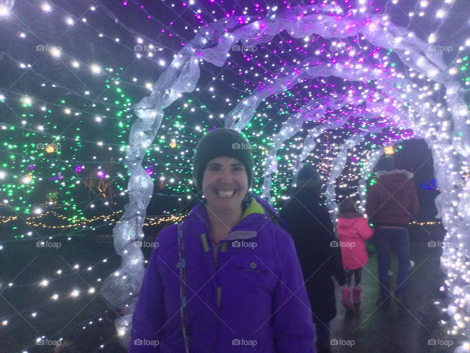 Woman in a tuque at a Christmas lights display 