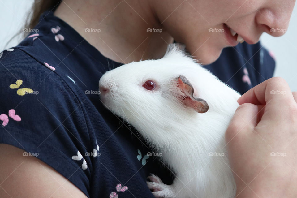 Girl holding her guinea pig