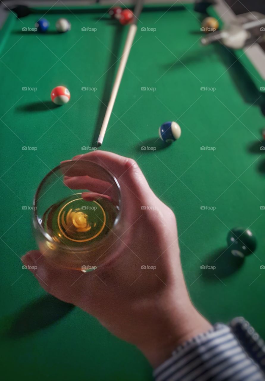 Whiskey and pool. Whiskey glass with pool table