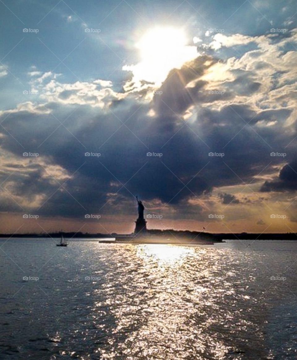 Sun shining on Statue of Liberty