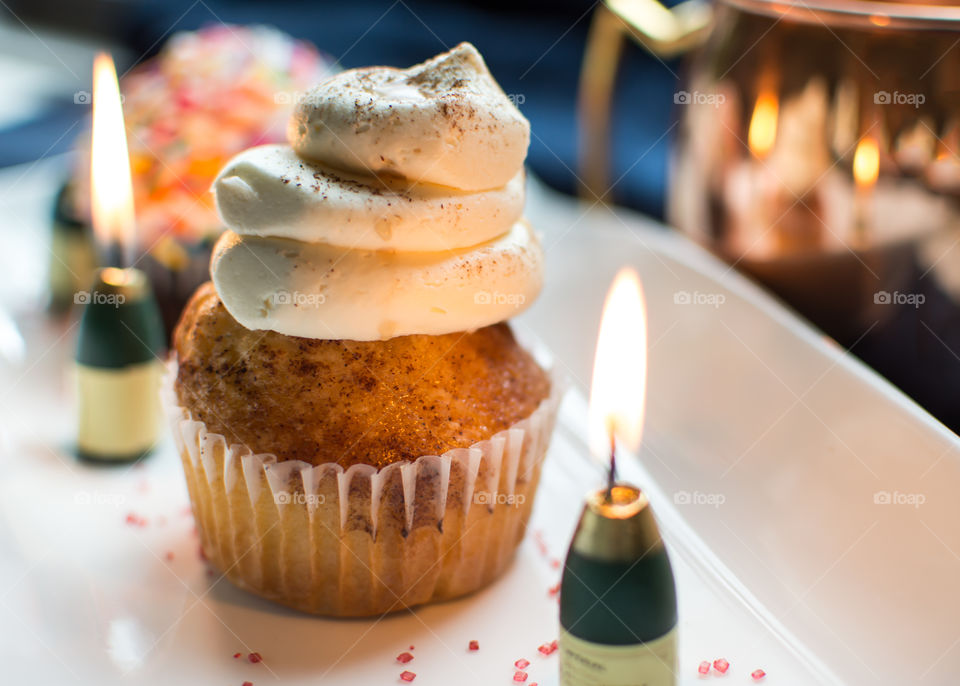 Elegant Cupcake with champagne candles and triple layer frosting 