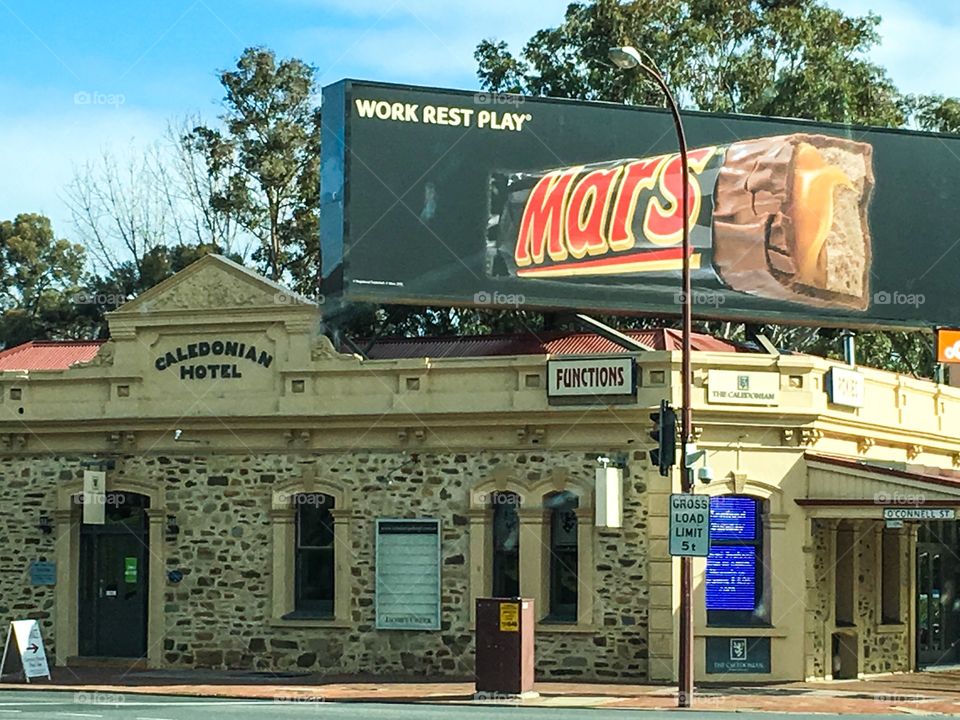 Adelaide south Australia. Large modern chocolate bar (Mars Bar) sign atop an old historic hotel